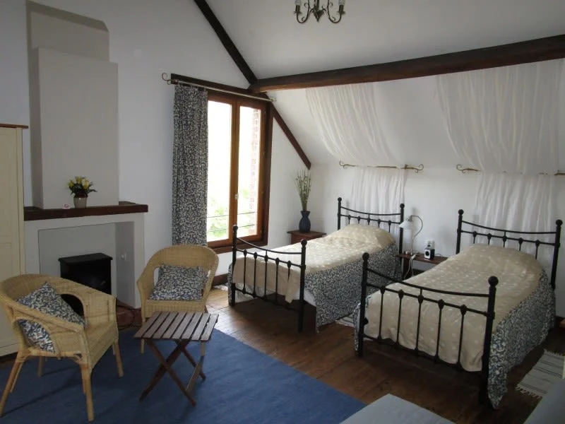 Elizabeth's Room configured as twin beds with exposed beams, Le Moulin St Blaise watermill