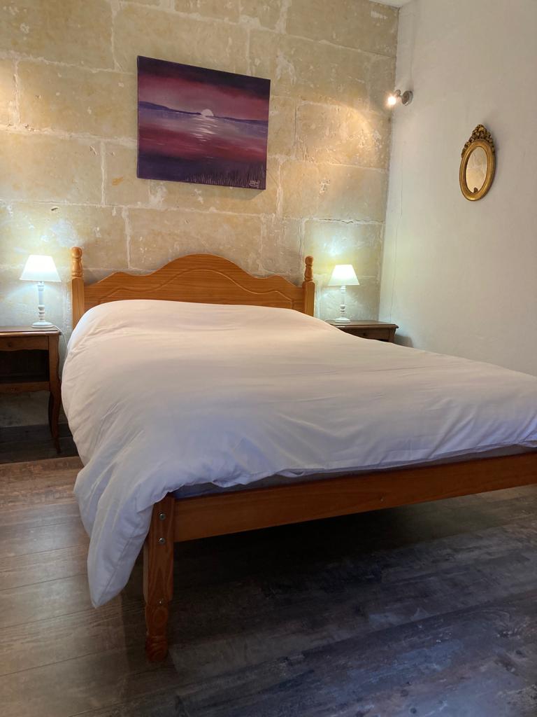 Master double bedroom with exposed stone walls in Gite La Maison du Frere, Moulin St Blaise watermill