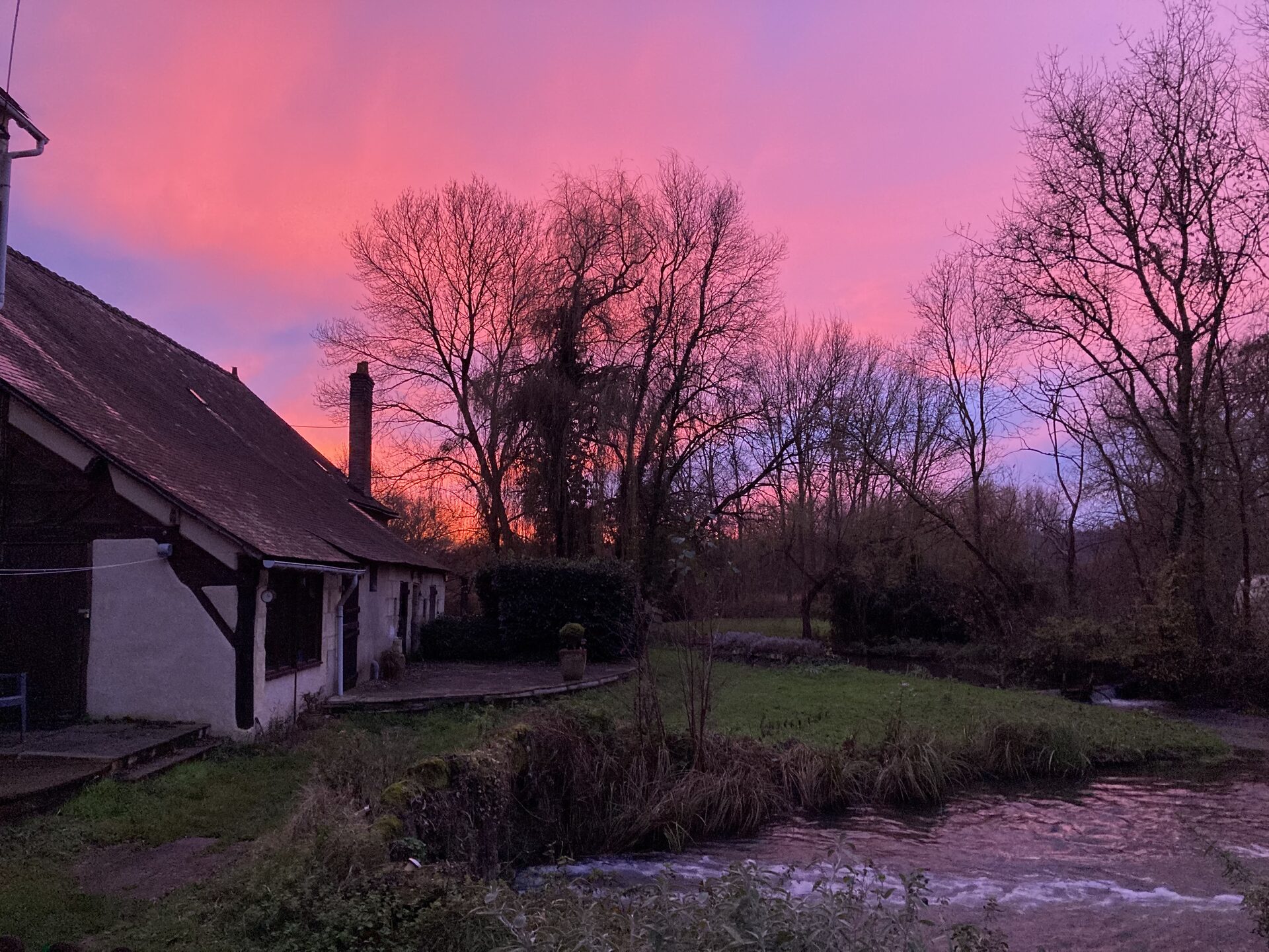 Spectacular pink and purple sunset over Moulin St Blaise and the La Veuve, Chahaignes, Sarthe