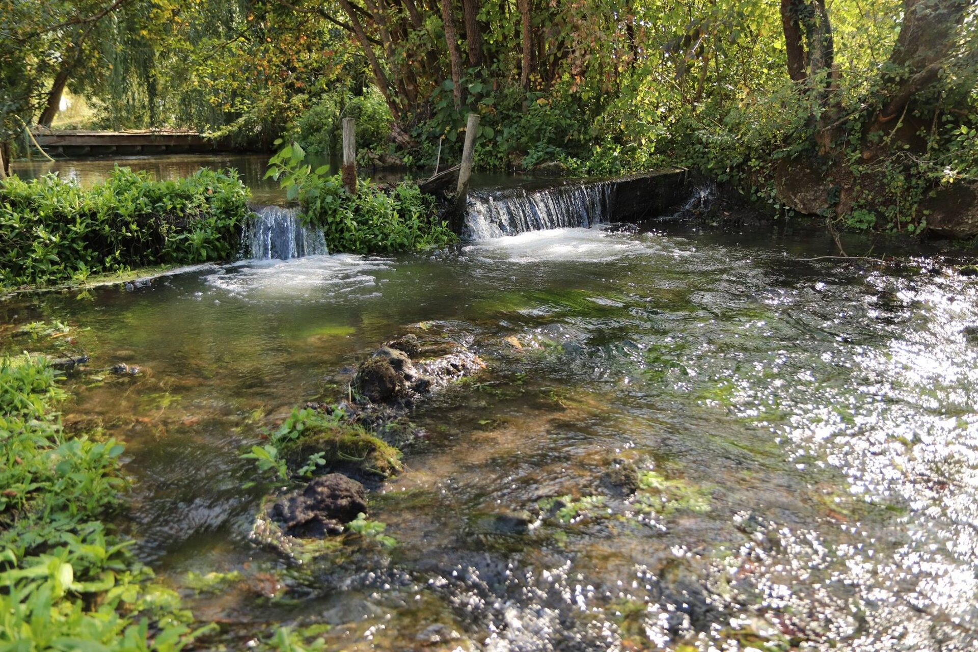 Crystal clear weir and waterfall in the grounds of Moulin St Blaise watermill, Loire Valley